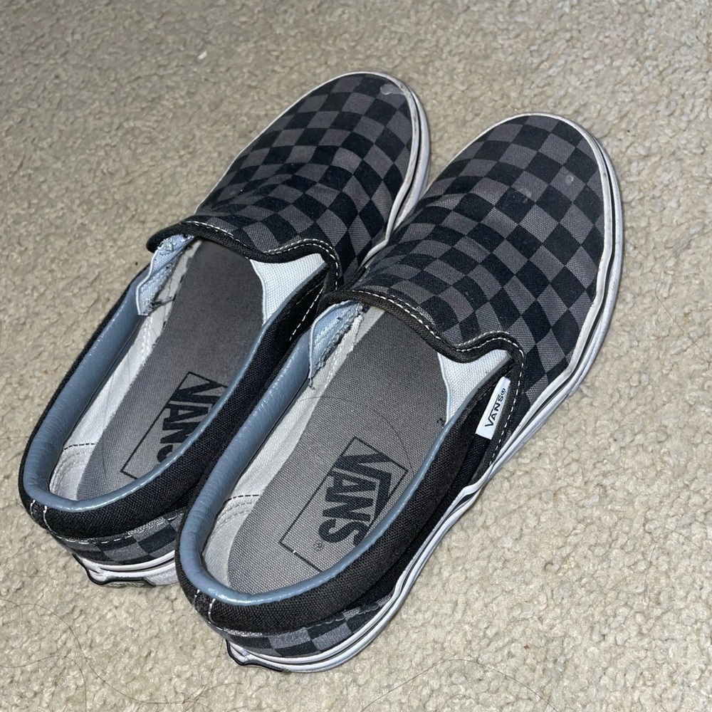 Black and gray checkered slip on vans